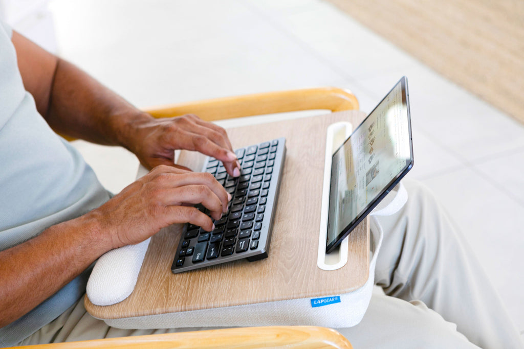 Person using a Portable Laptop Lap Desk with a 15.6-inch laptop on their lap, working comfortably in a seated position.