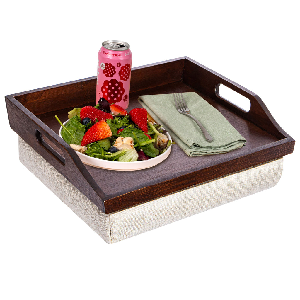 Wooden tray with salad, pink can, and napkin on a white background