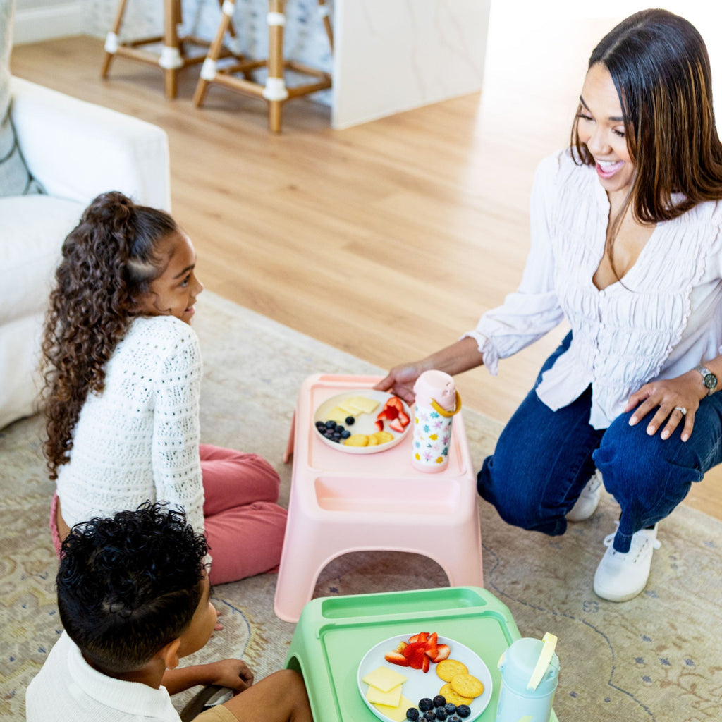 Mom serving snacks to kids who are using their Turtle Table to eat. 