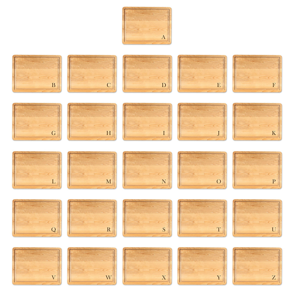 Set of 26 maple cutting boards letter engravings in the bottom corner using baskerville font, from A to z on a white background
